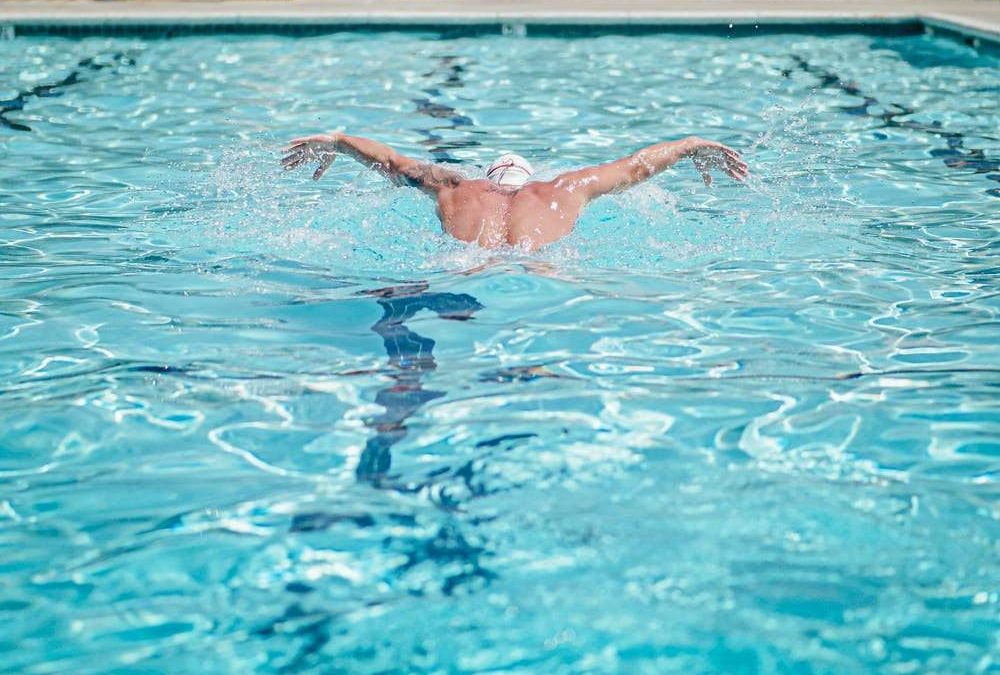 A man swimming in breaststroke style
