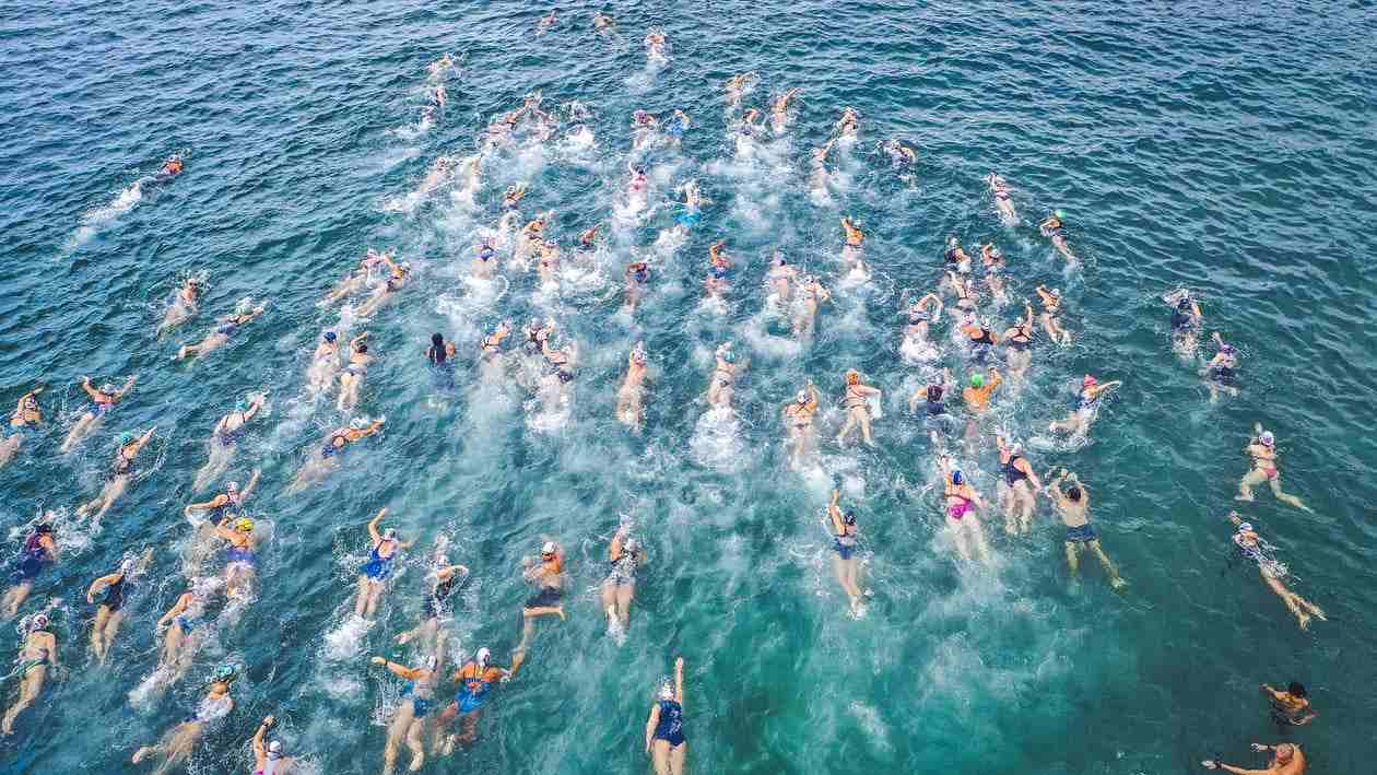Competitive swimming in open waters.