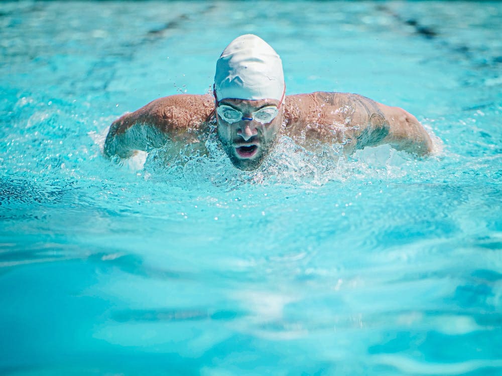 Man Wearing Goggles in freestyle stroke. 
