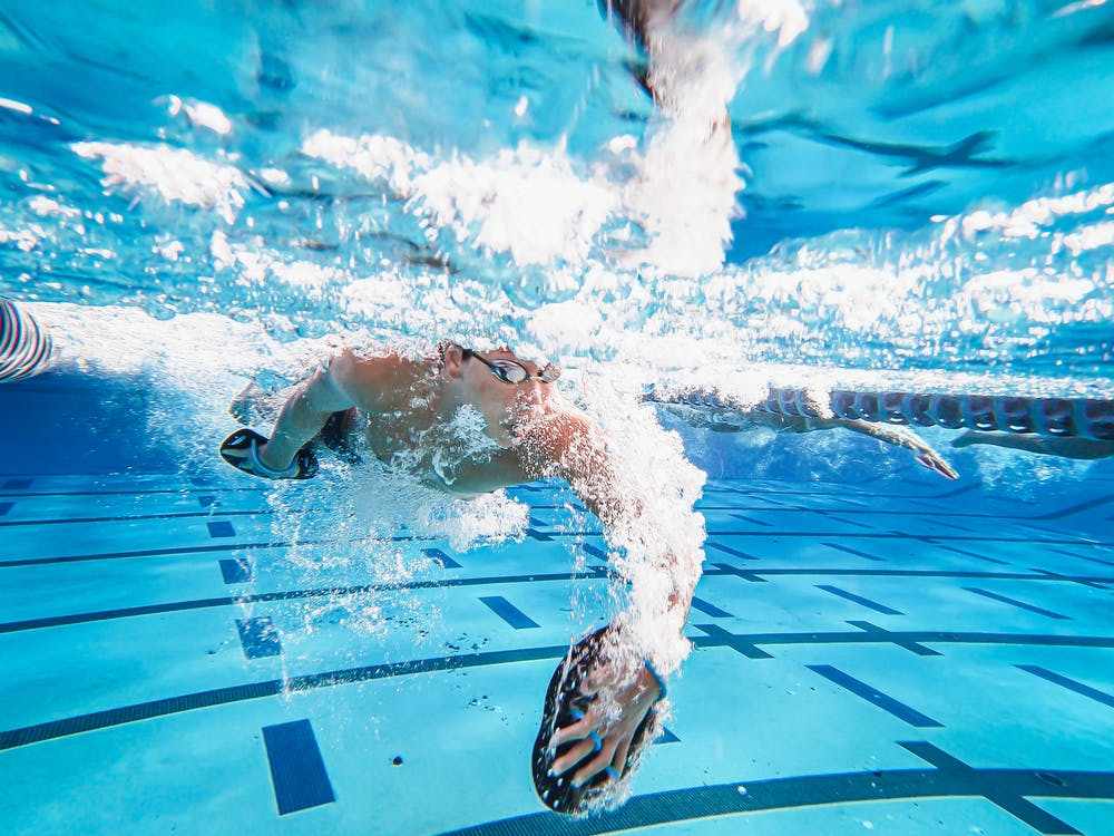 Free Man in Black Sunglasses Swimming in Pool Stock Photo