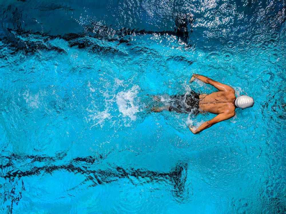 A professional swimmer swimming in the pool.