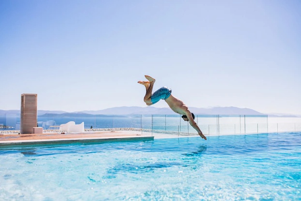 Man jumpinhg into the pool