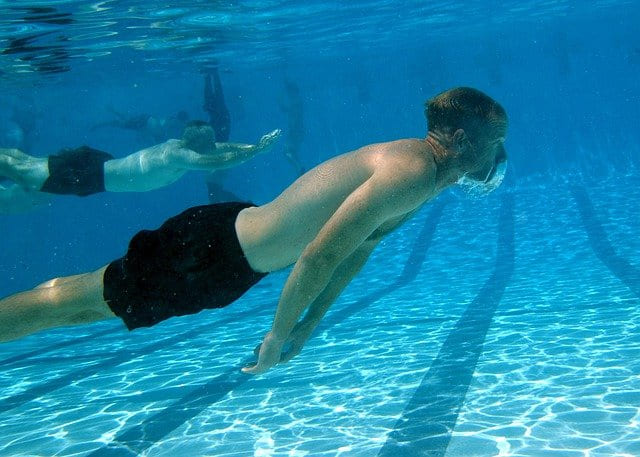 man doing breathing exercise underwater