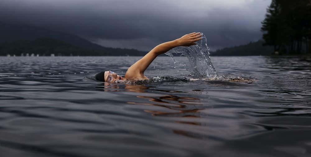 man swimming on body of water
