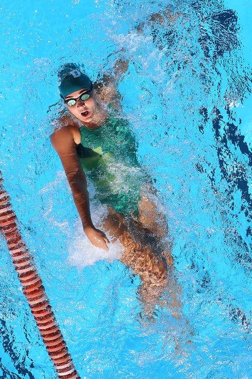 Free Woman In Green Swimsuit Practicsing Backstroke.